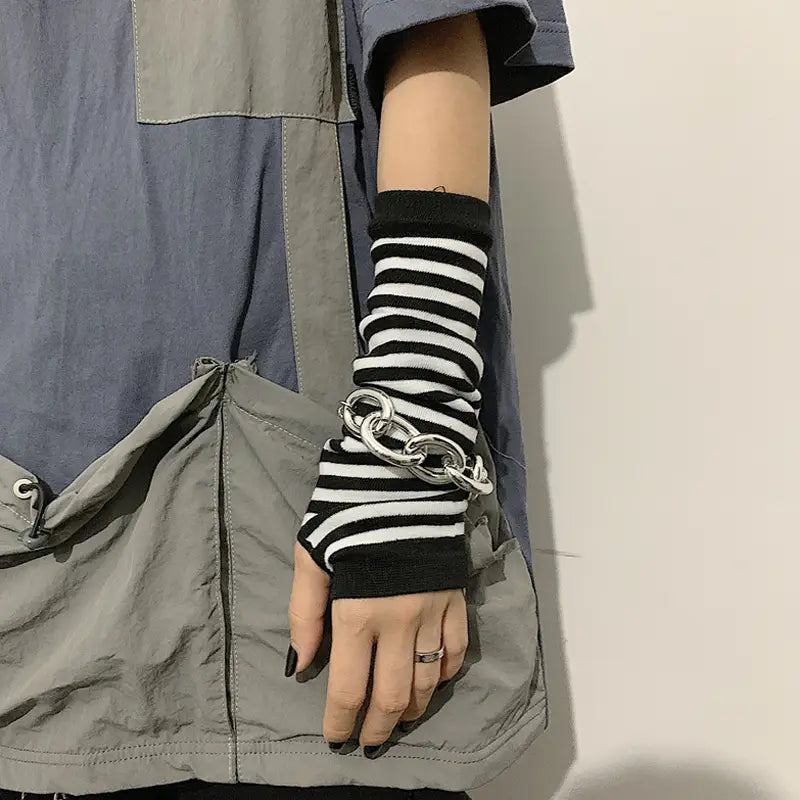 black and white striped knit fingerless arm warmers with silver chain link detail made from soft knit material