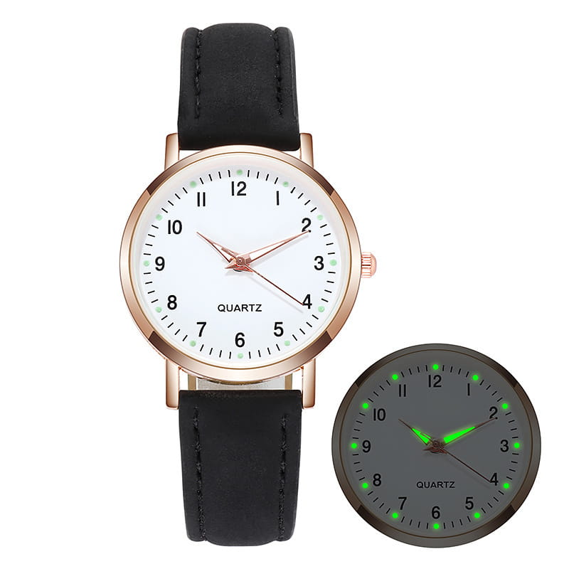 A rose gold women leather quartz watch with a sleek black leather strap, white dial, and glowing green hour markers in the dark.