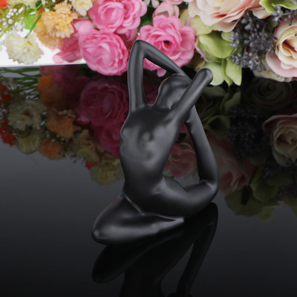 black glossy ceramic figurine of a seated woman in a yoga pose from the glossy resin yoga figurine set