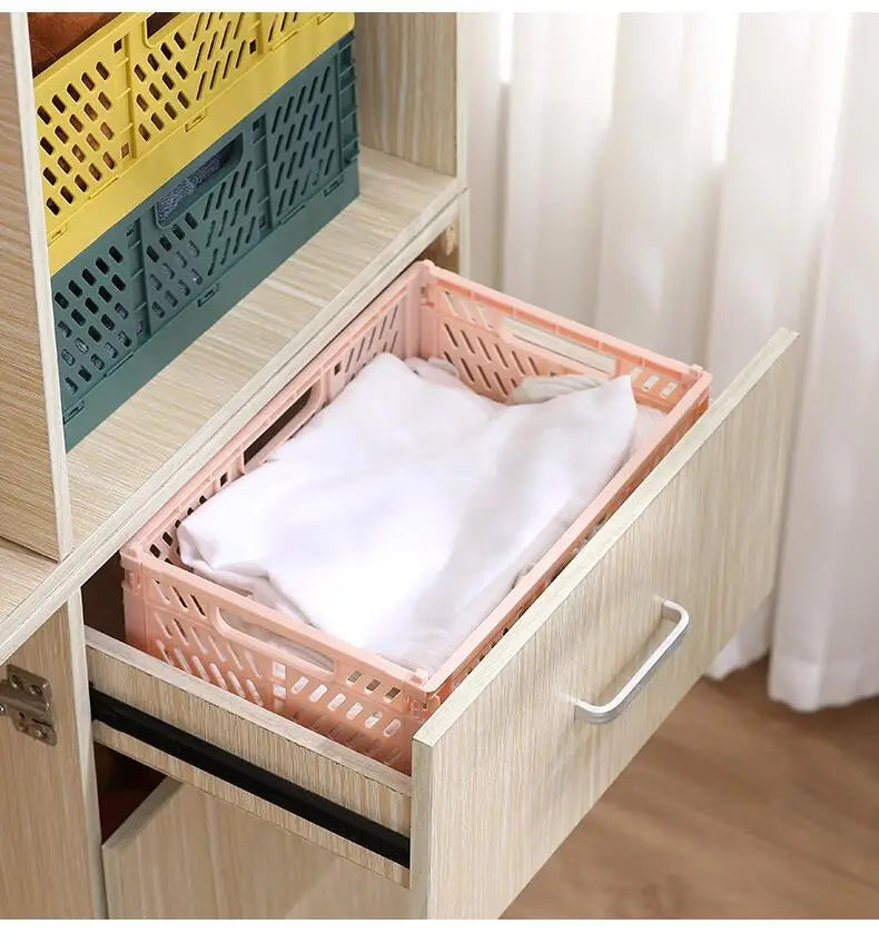 Pink plastic foldable storage basket with lattice design containing a white garment for foldable storage solutions.