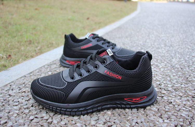 Men breathable athletic sneakers running shoes in black with red accents and a mesh upper featuring fashion branding on the side.