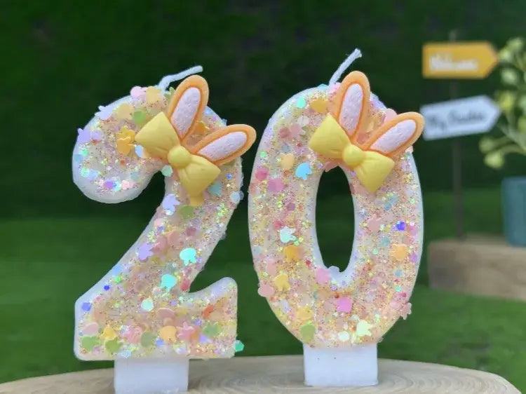 Pastel glittery number 20 birthday candles with yellow bow and bunny ears decorations featuring glitter bunny ear number birthday candle design.