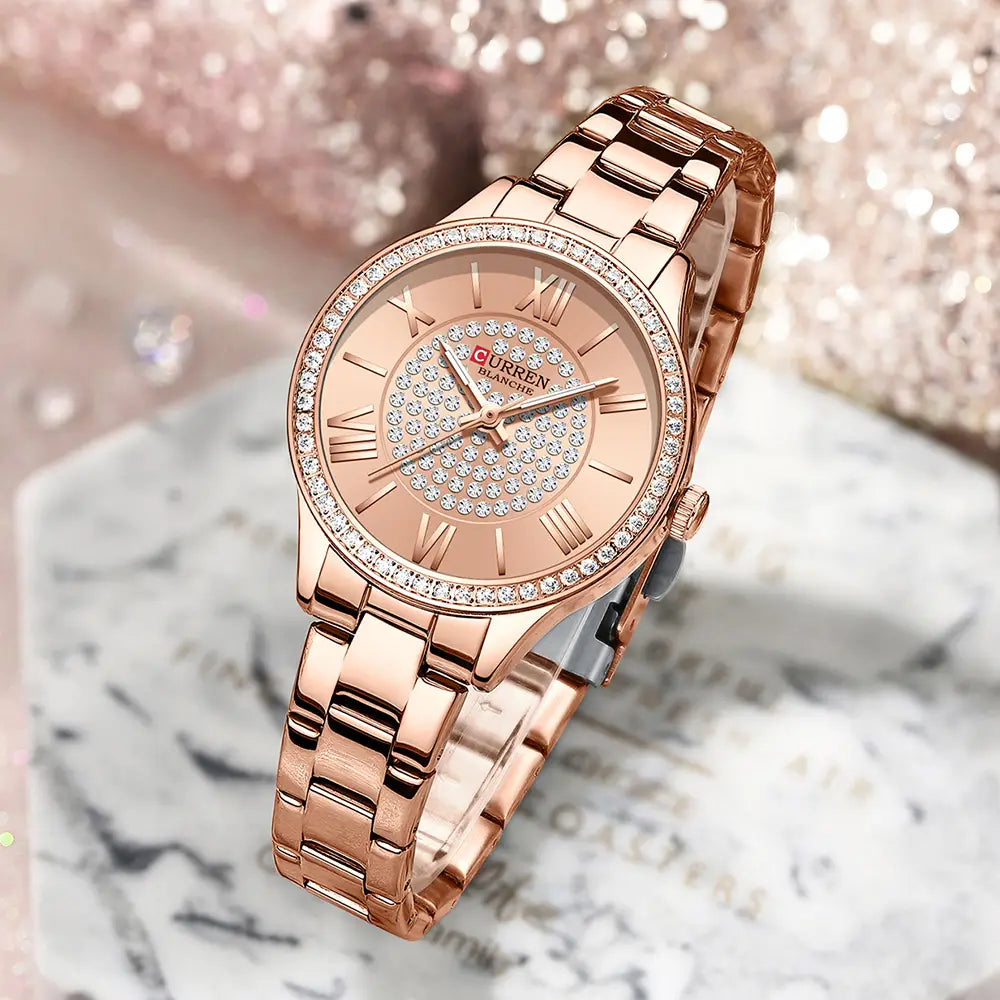 Rose gold curren women stainless steel crystal quartz watch with a diamond studded bezel and face featuring roman numerals on an elegant metal bracelet.