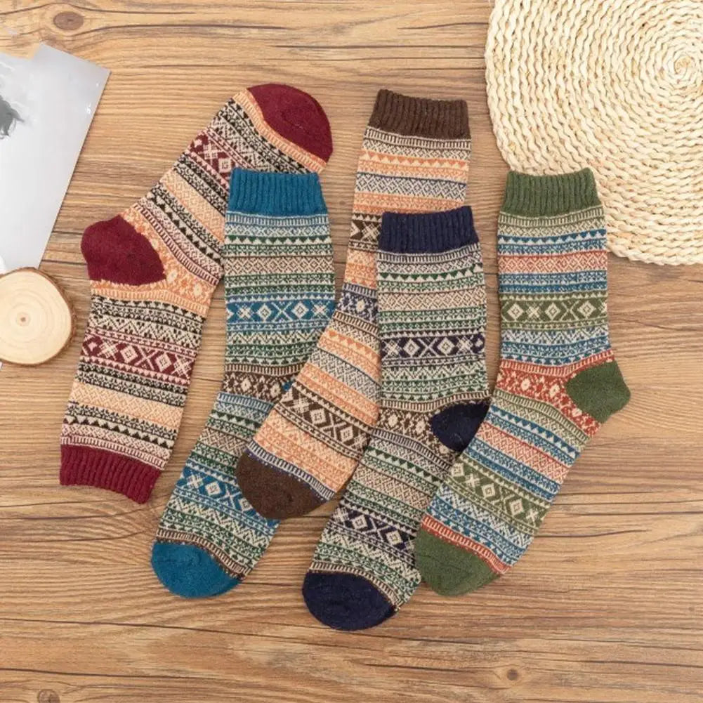 Men retro cotton crew socks mid-high tube thermal teal featuring four pairs of cozy multicolored knit socks with intricate geometric patterns and contrasting toe and heel accents, perfect for fashion trend enthusiasts.