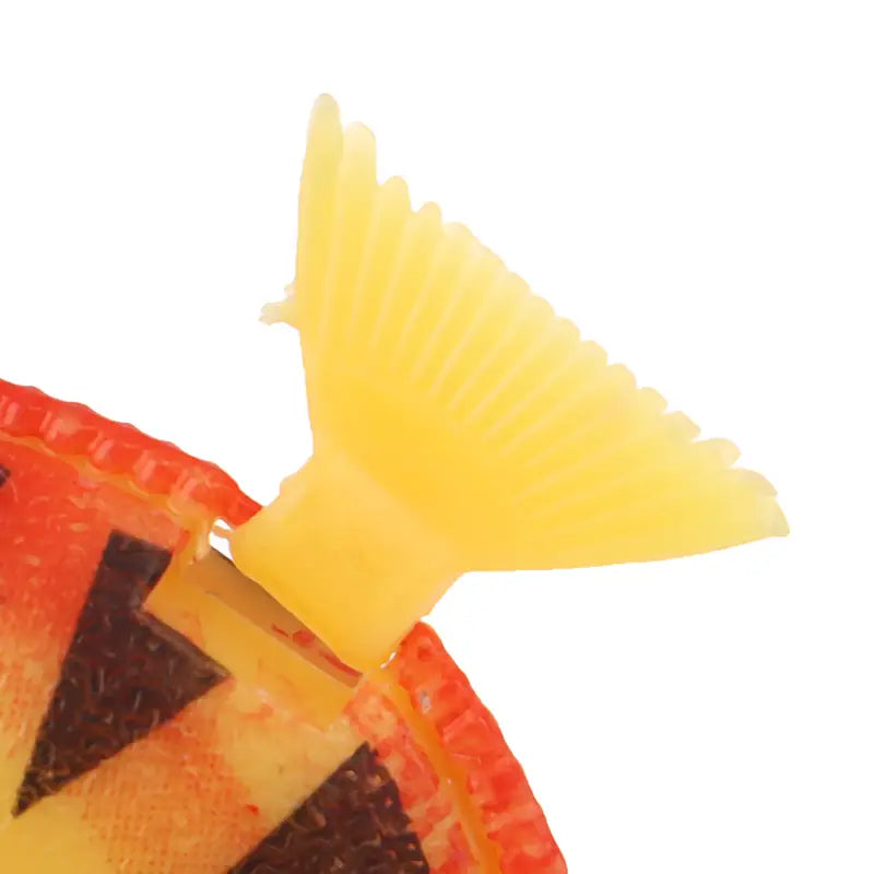 Yellow plastic floating fish tail featuring an orange and black pumpkin face design for aquarium fish decor in a 10 pack floating fish set.