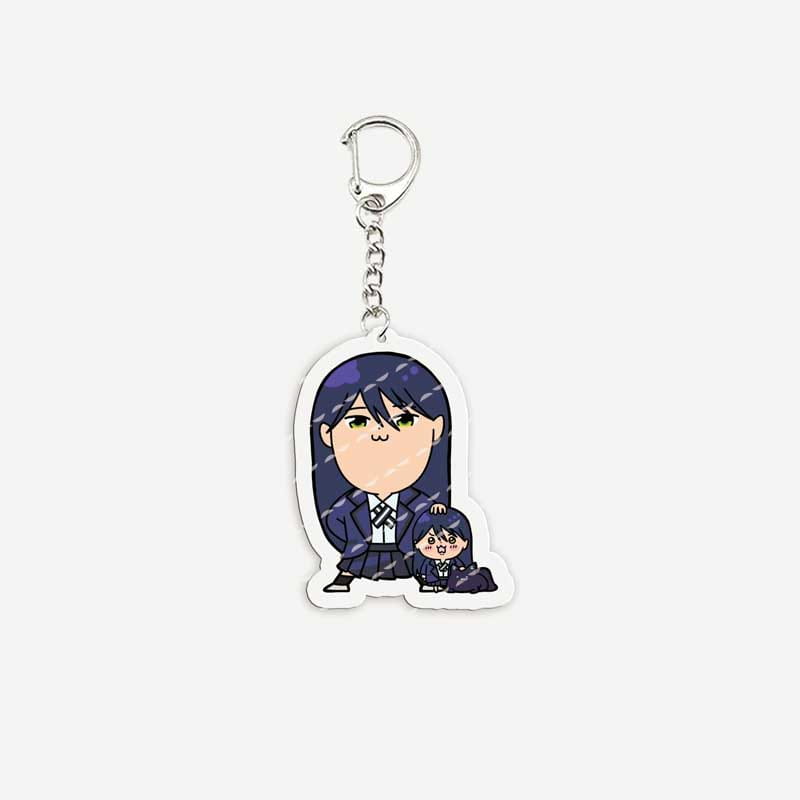 A clear acrylic anime chibi keychain featuring a chibi-style illustration of two characters in school uniforms with one character having long dark hair and a smaller character beside them.