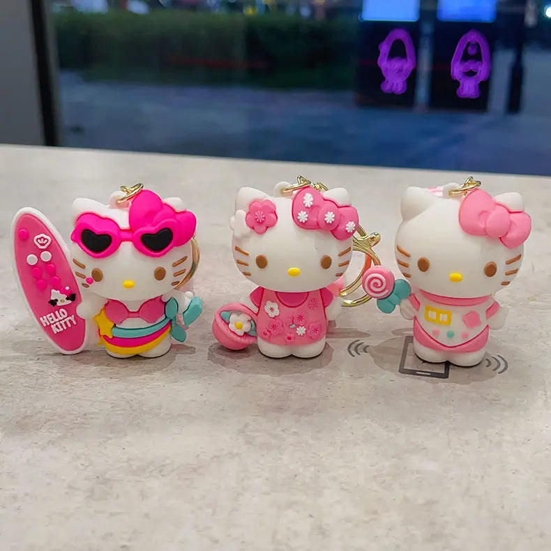 hello kitty cartoon keychain anime bag charm featuring three pink and white keychains with unique designs including sunglasses floral dress and polka dots.