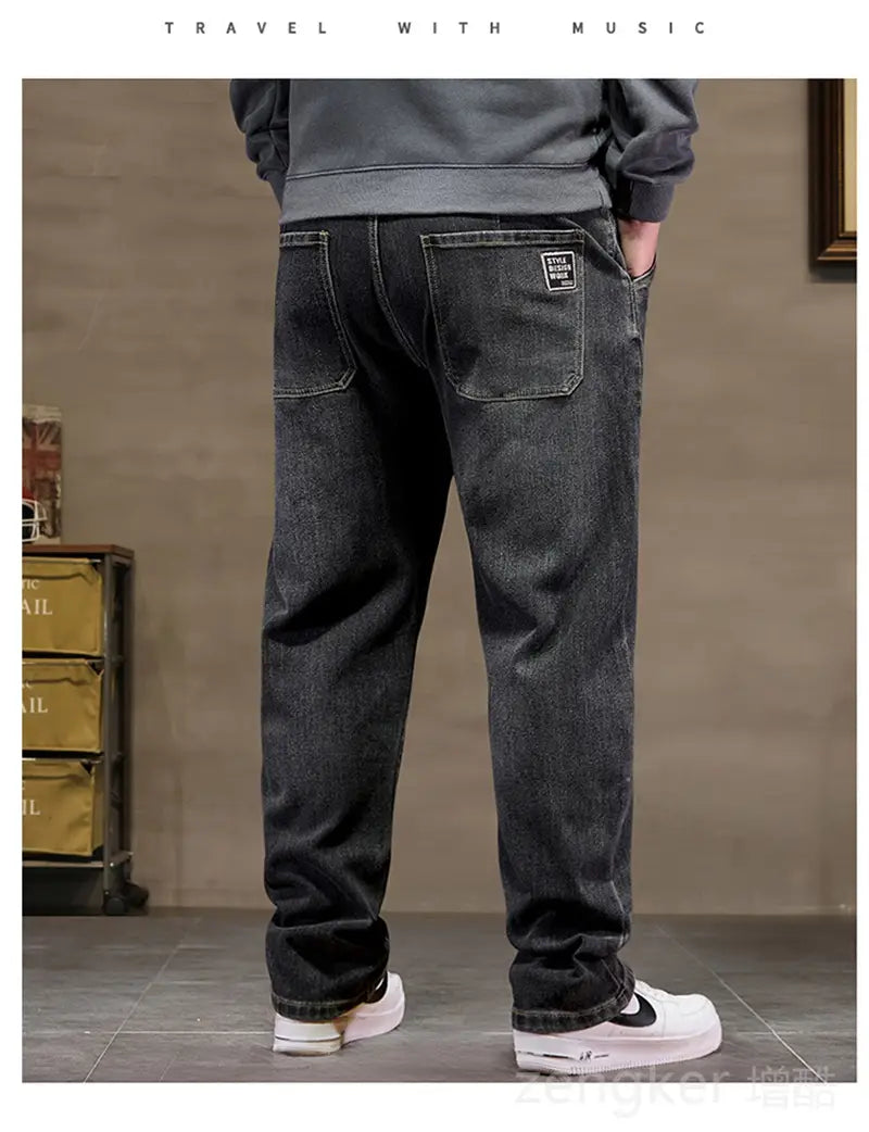 plus size elastic waist loose straight dark-wash denim jeans shown from the back with relaxed fit and classic back pockets featuring subtle stitching details.