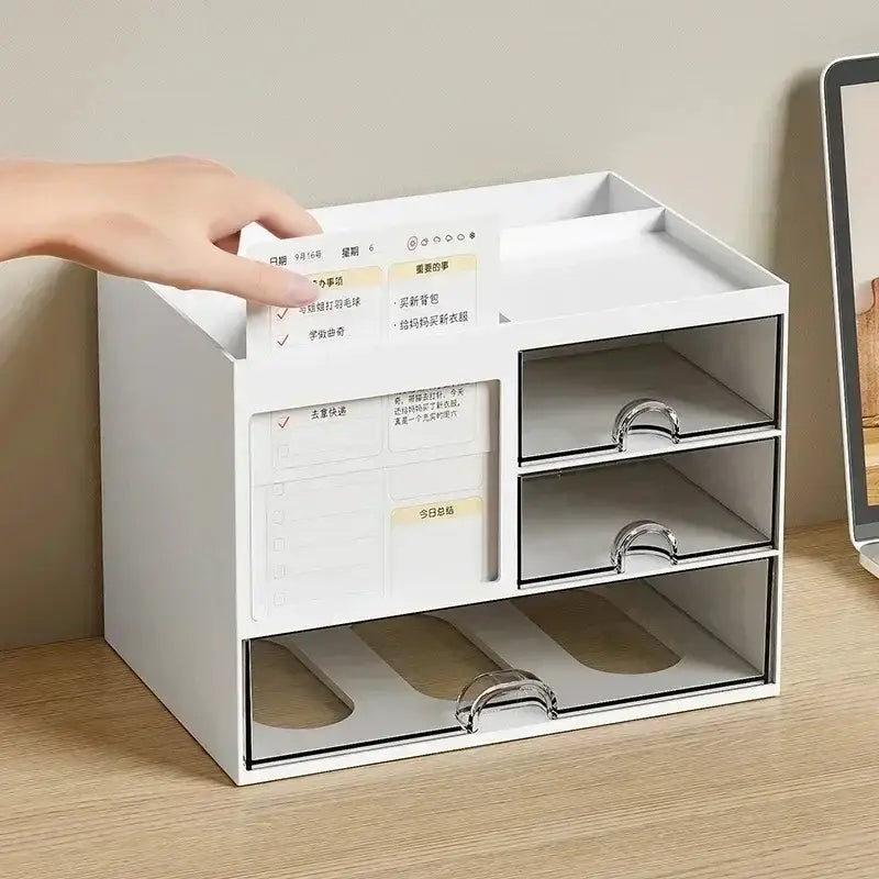White plastic desk organizer with three clear drawers featuring silver handles and a built-in planner section for efficient workspace organization.