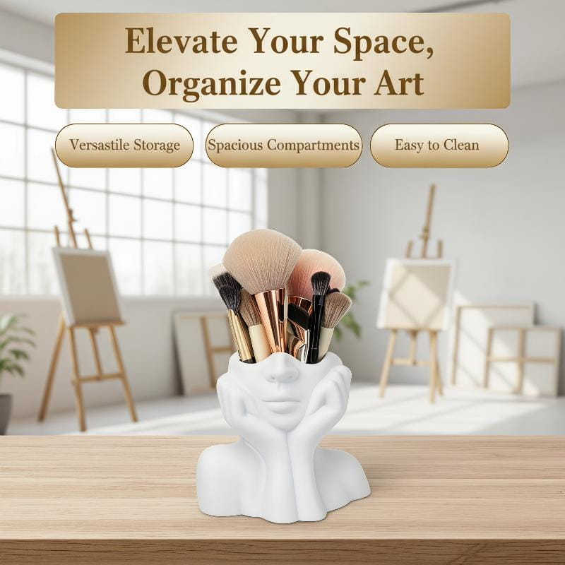 White ceramic abstract face makeup brush holder shaped like a human head with hands supporting the chin, also usable as a vase.