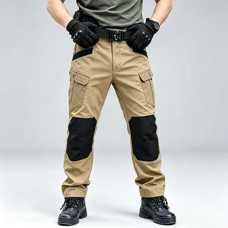 Men winter tactical cargo pants in tan with black reinforced knee patches and multiple cargo pockets designed for waterproof hiking use.