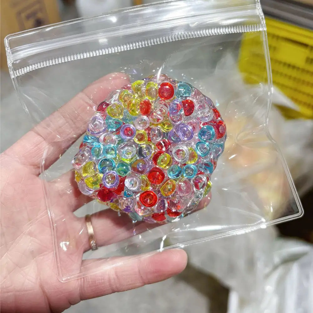 Jouet anti-stress à perles de glace en gel à presser, en gel translucide coloré, rempli de perles de gel multicolores rouges, jaunes, bleues et violettes.