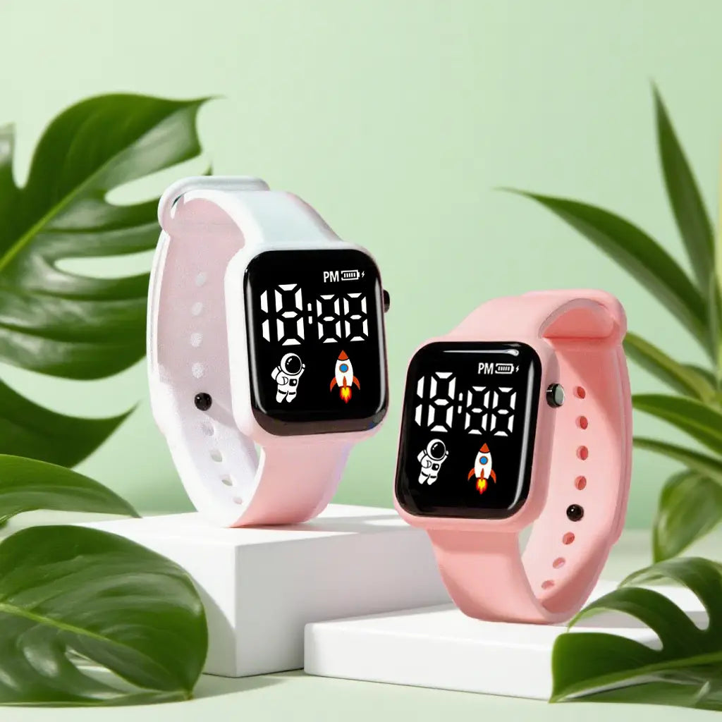 Montre électronique pour enfants rose et blanc, avec affichage numérique sportif LED et thèmes d’astronaute et de fusée pour garçons et filles.
