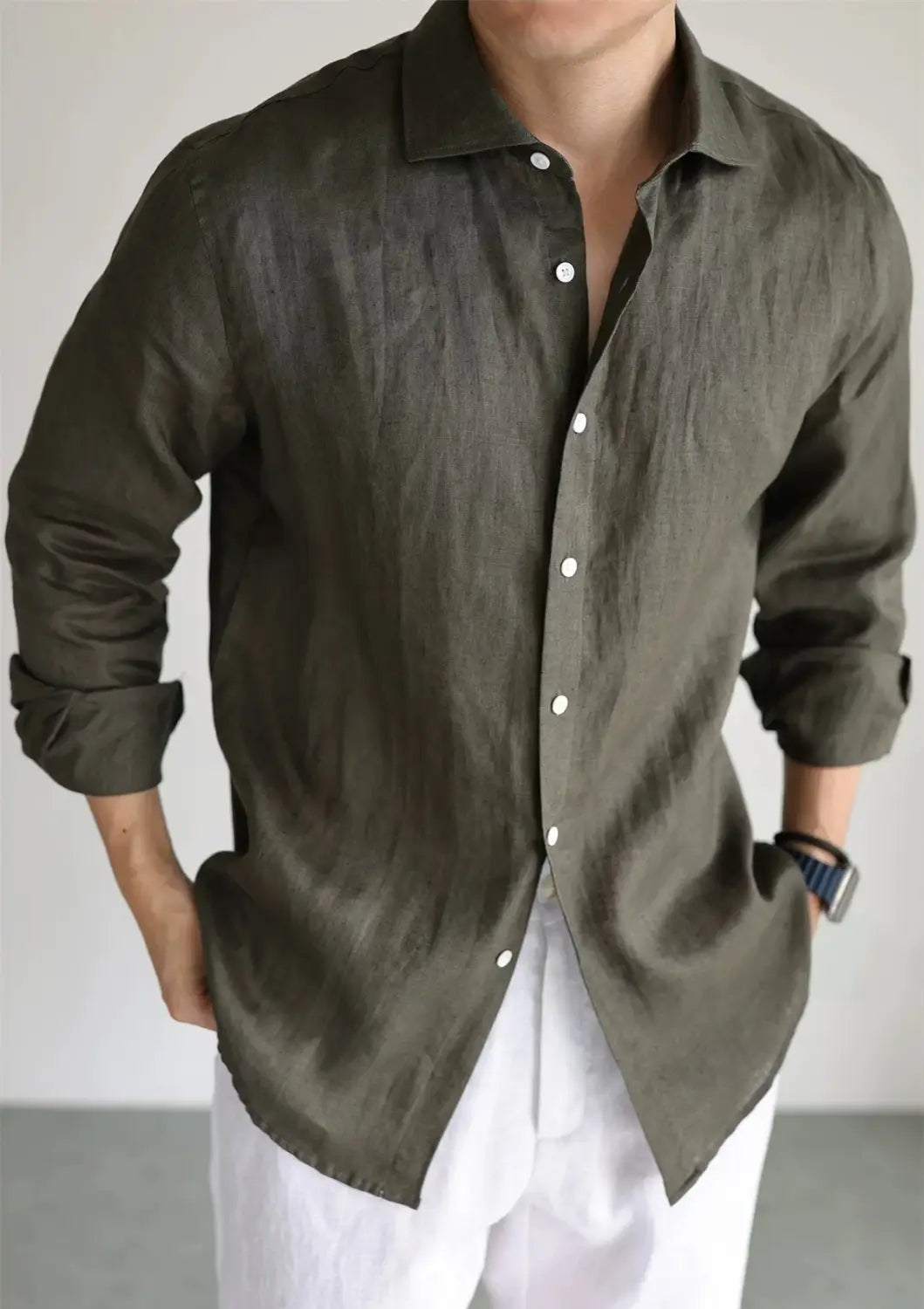 Olive green men cotton linen casual button down shirt with white buttons and rolled up sleeves.