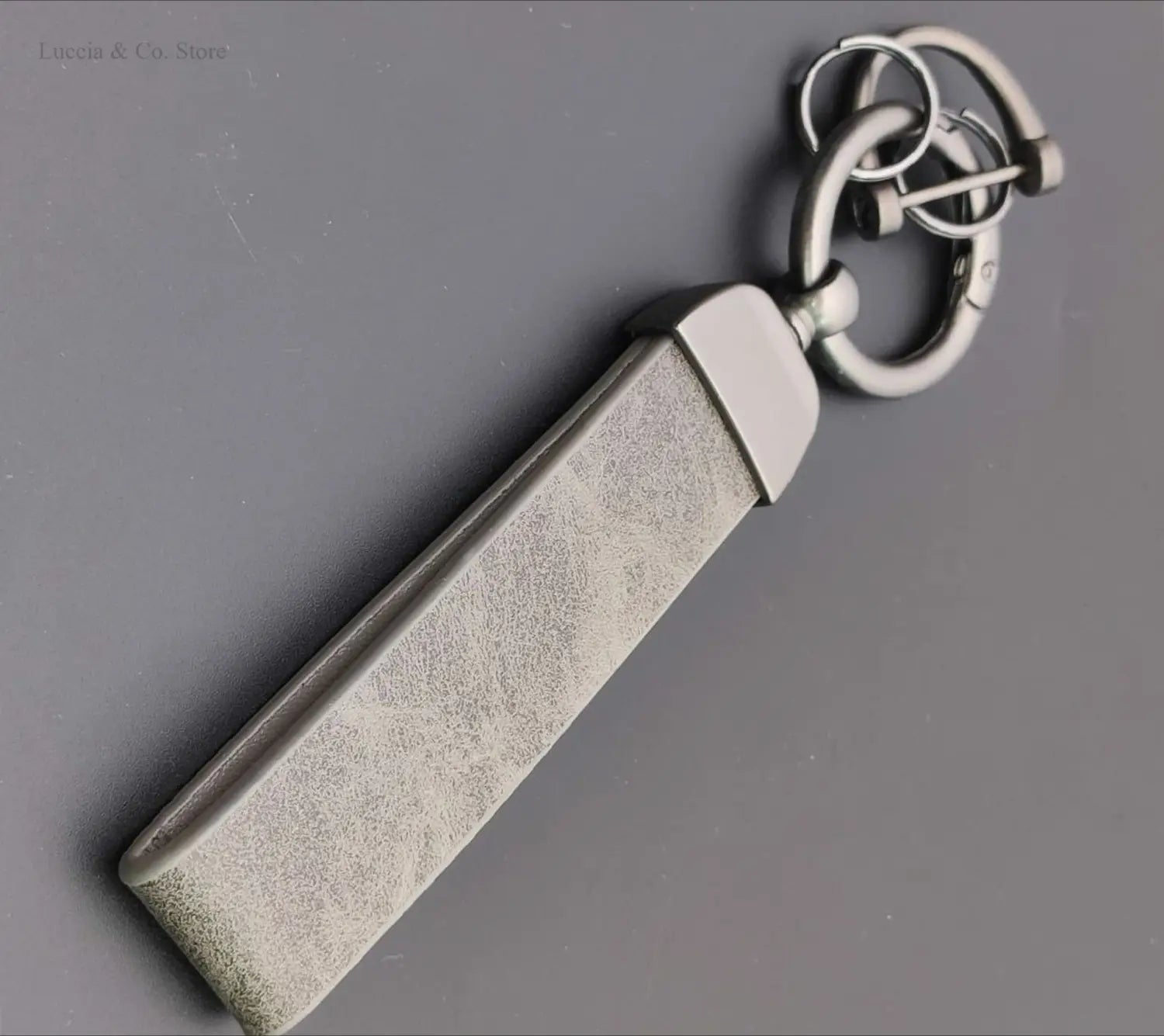Silver-toned rectangular custom logo car keychain with textured matte-finished metal surface and polished hardware for personalized use.