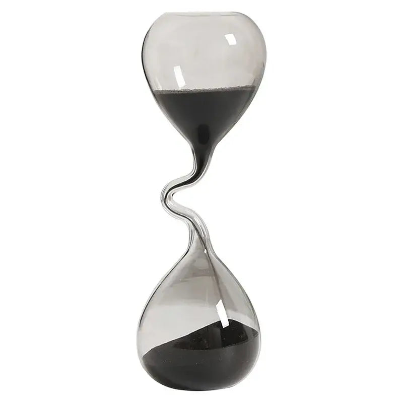 A sleek transparent glass sand timer hourglass with a twisted central neck and dark sand flowing between two bulbous chambers for elegant home decoration.