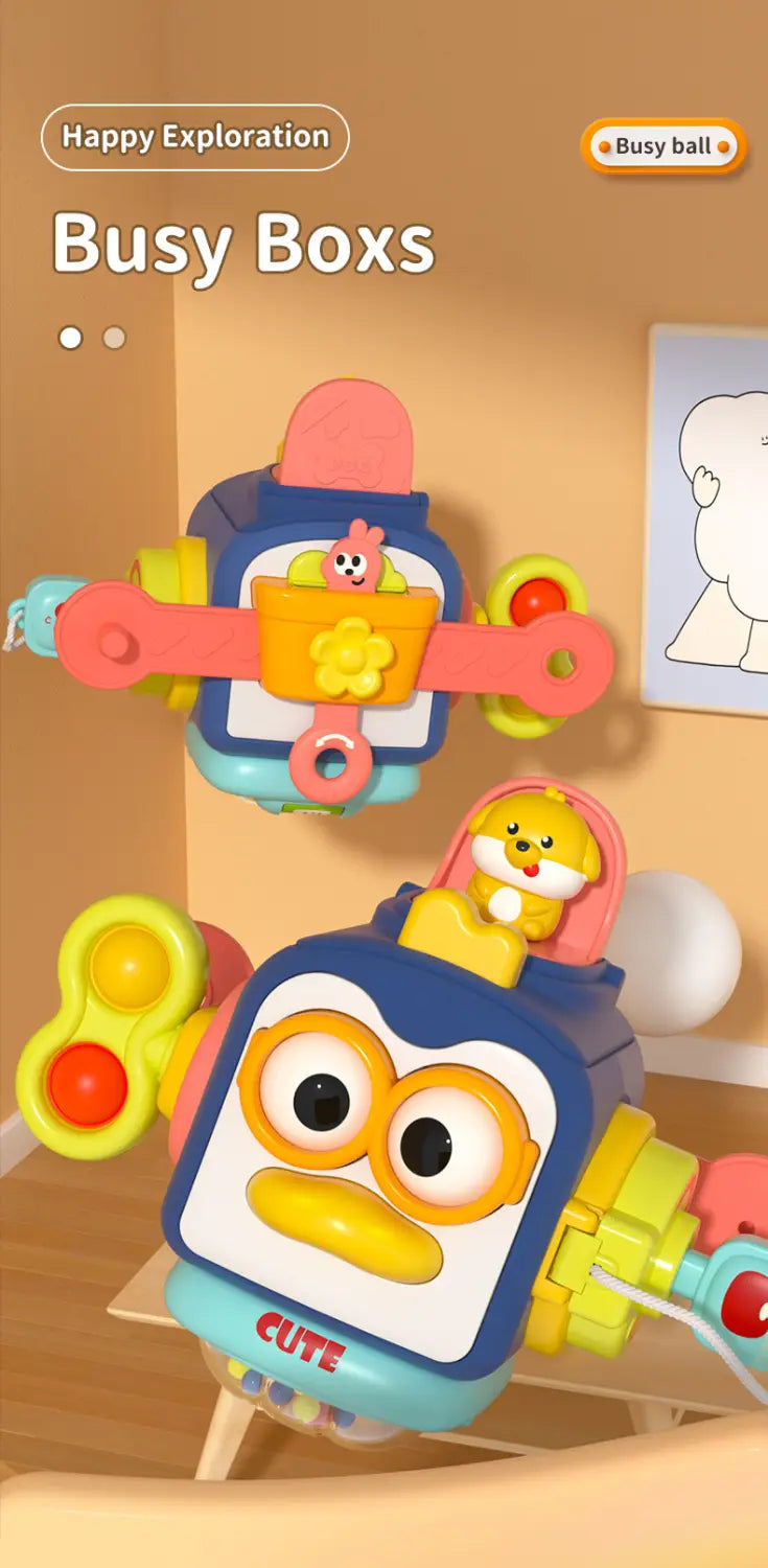 Joli jouet de voyage cube d’occupation Montessori en forme de robot bleu et jaune, avec des boutons interactifs colorés et une petite figurine d’animal en haut.