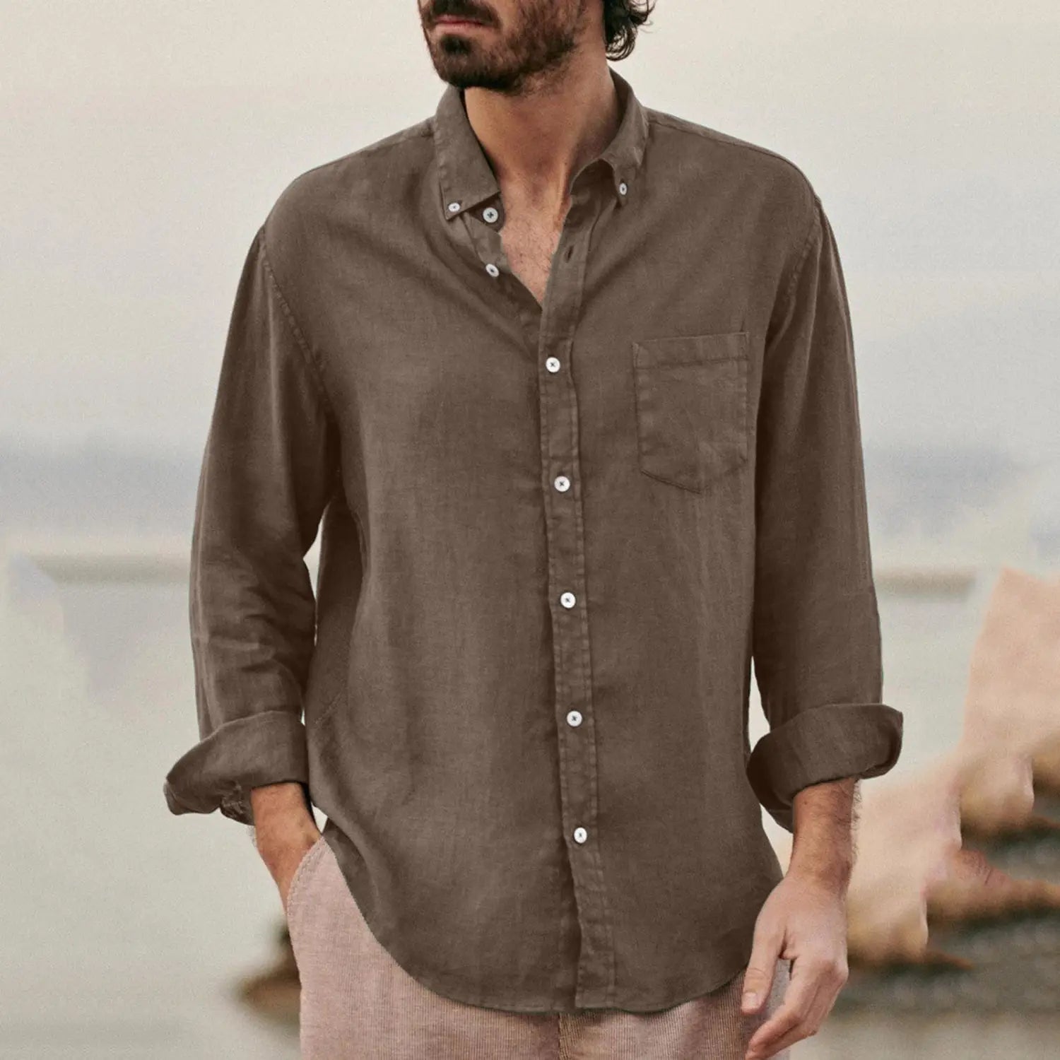 A men linen blend casual shirt in muted olive green featuring long sleeves, a lightweight linen fabric, rolled cuffs, and a single chest pocket.