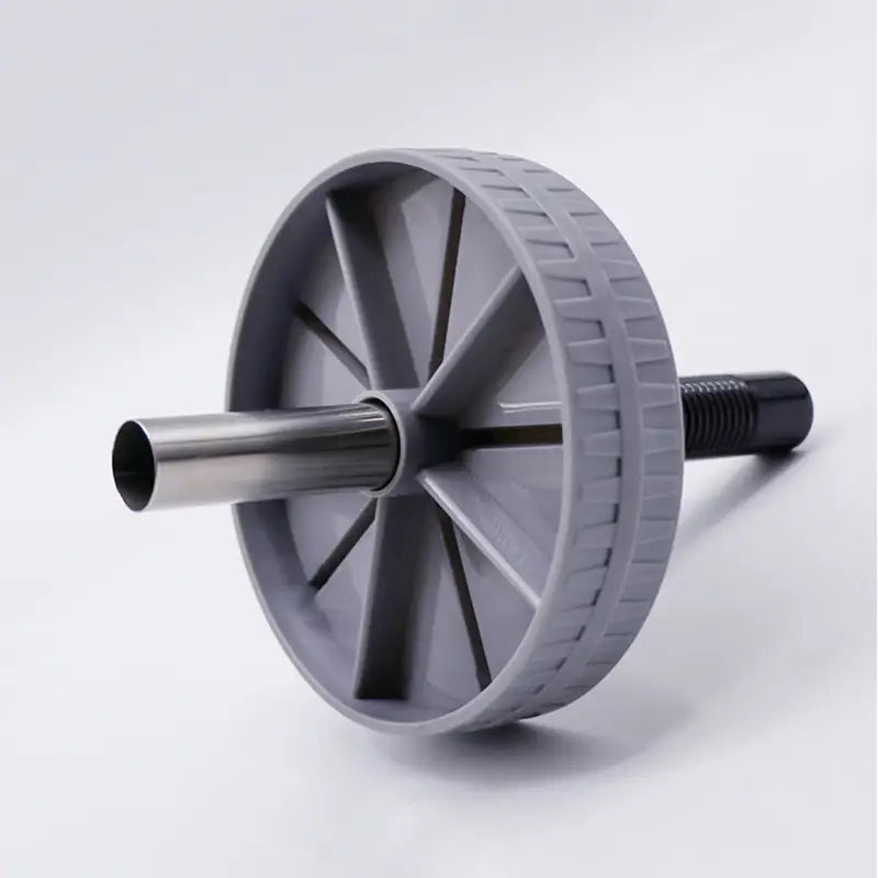 Roue d’exercice abdominale silencieuse « ab roller » en plastique gris avec essieu argenté métallique et poignée filetée noire, pour le renforcement du tronc.