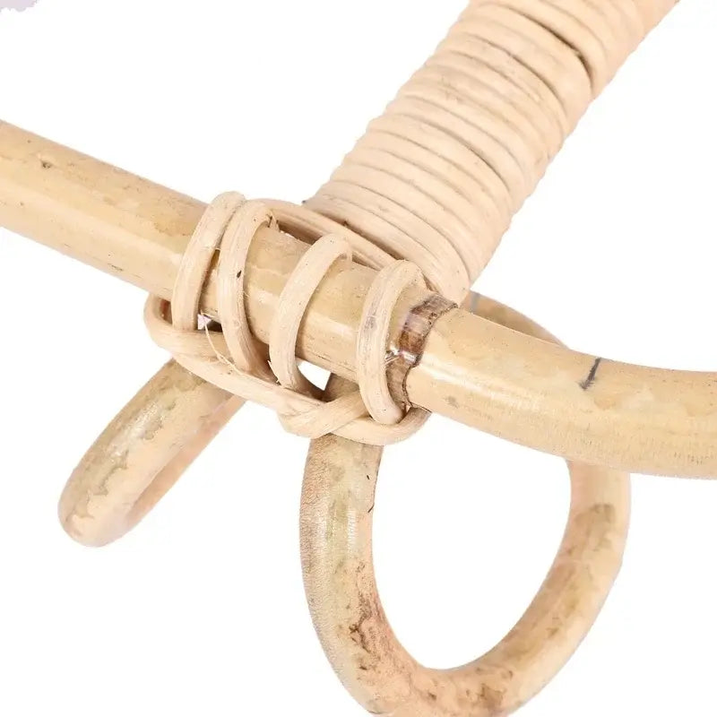 Natural beige rattan 5 hook kids wall hanger organizer with woven and twisted strands forming a sturdy interlaced joint.