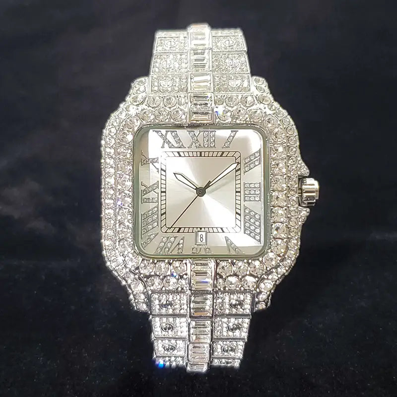 An iced out diamond square watch for men with a dazzling square-faced diamond-encrusted silver-toned metal band and roman numeral markings.