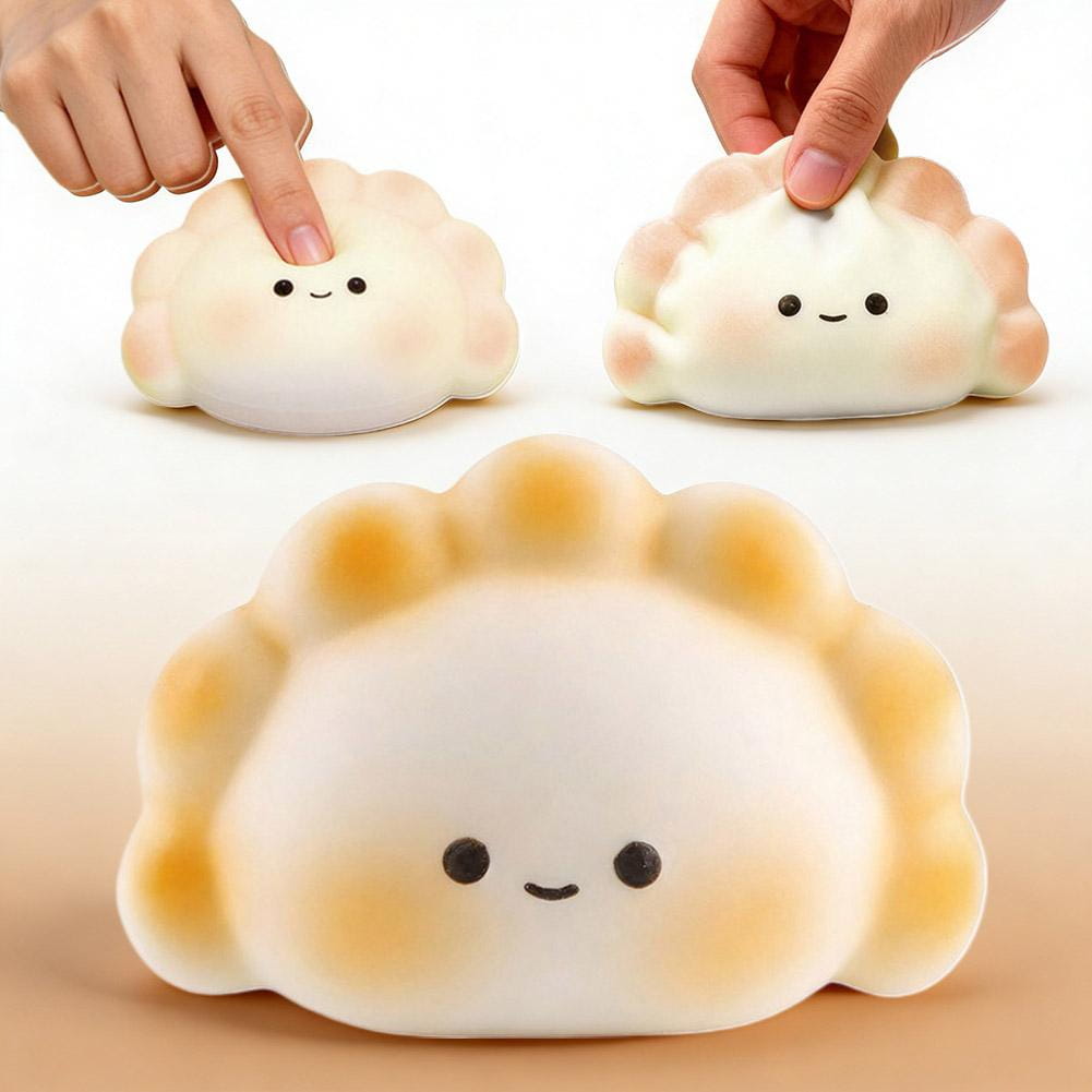 Lindo juguete exprimible de dimsum en color blanco y beige para aliviar el estrés, elaborado con material flexible, con ojos de puntos negros y boca sonriente, para juguetear y aliviar la ansiedad.