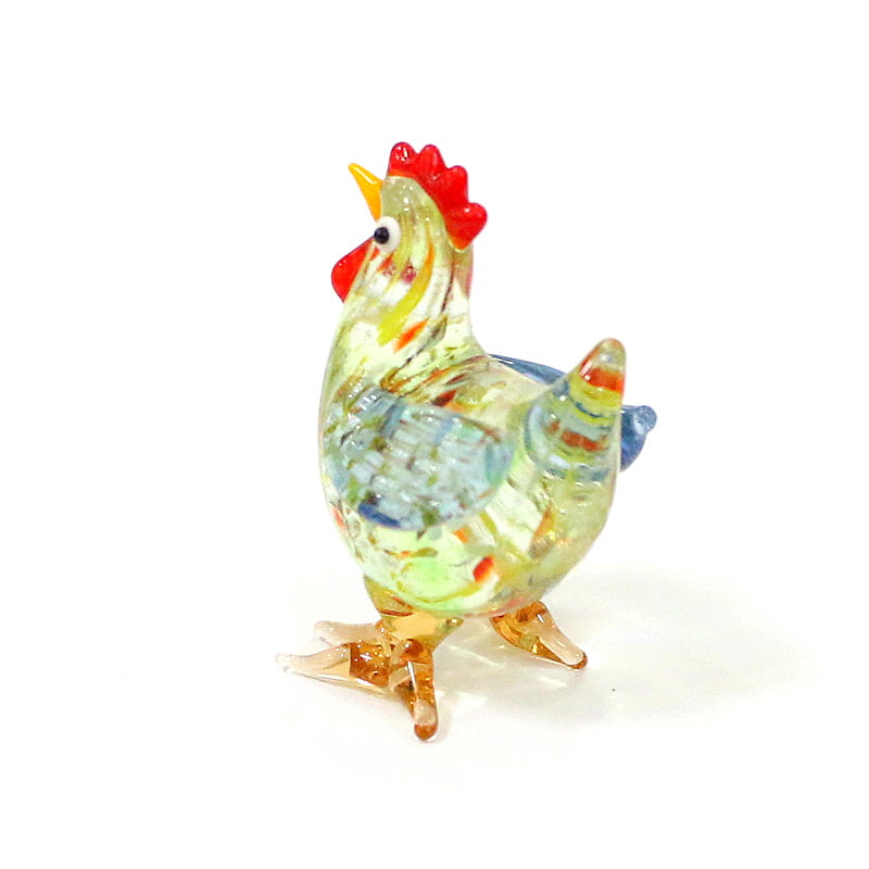 A vibrant hand-blown glass rooster miniature figurine Easter ornament with a translucent yellow body adorned in swirling blue and orange patterns, featuring a bright red comb and wattle, amber-colored feet, and a small yellow beak.