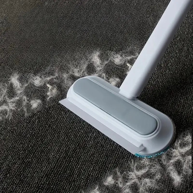 White and gray reusable pet hair remover carpet sweeper with a soft bristle head designed for efficient pet hair removal from furniture and carpets.
