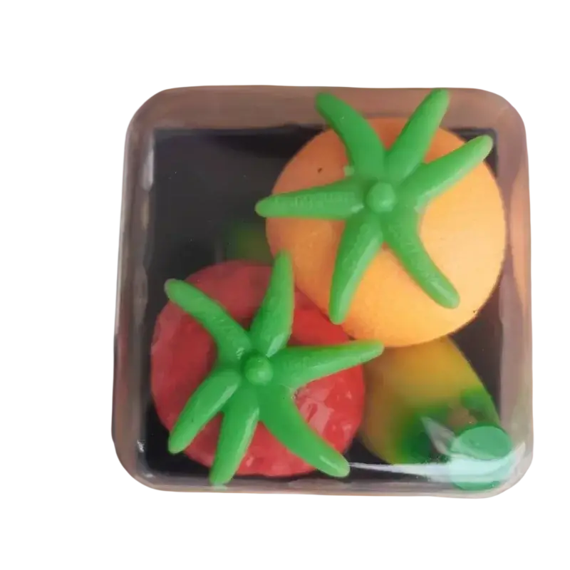 Front view of bright orange and red tomato-shaped stress balls with green tops in a clear container for stress relief