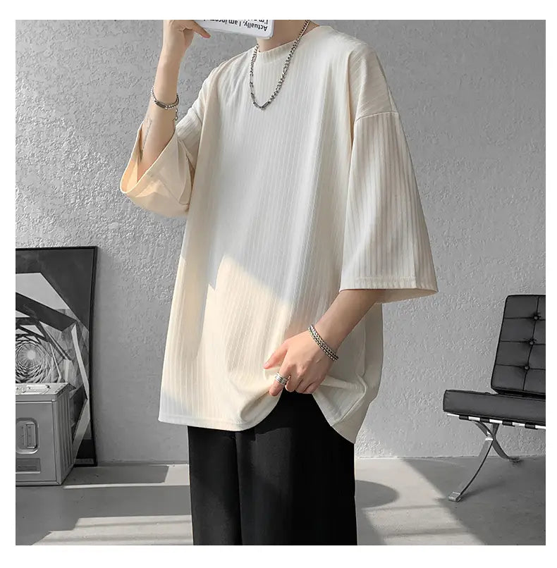 Men striped oversized summer tshirt in cream color featuring loose fit short sleeves and subtle vertical ribbing.