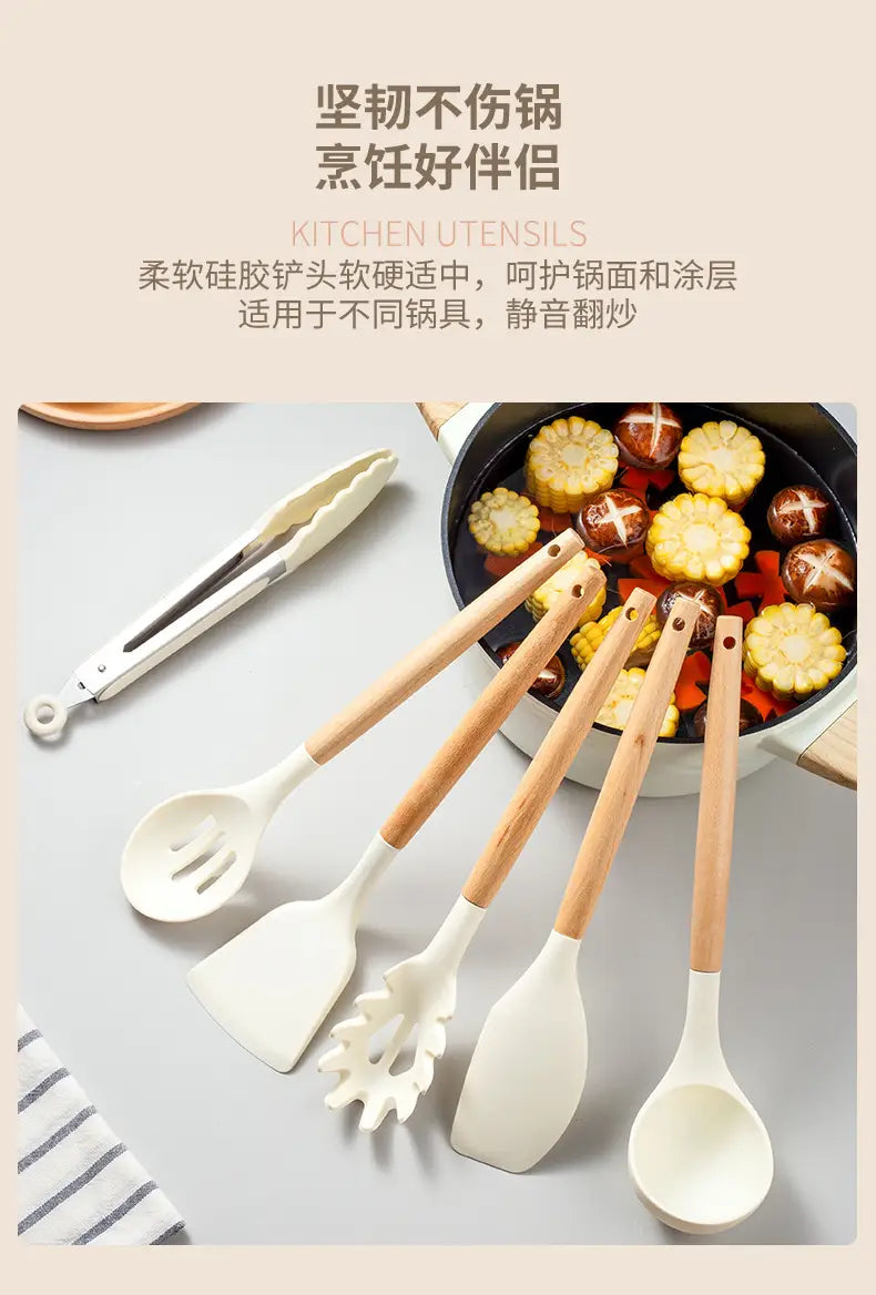 Set of five white silicone kitchen utensils with wooden handles including a spatula spoon and slotted spoon for cooking and food preparation.