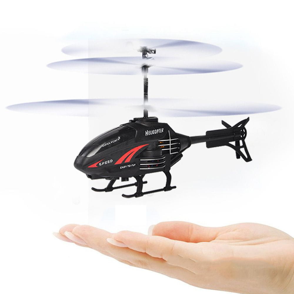 A black and red flying helicopter toy with super power branding hovering above an open palm, featuring usb rechargeable functionality.