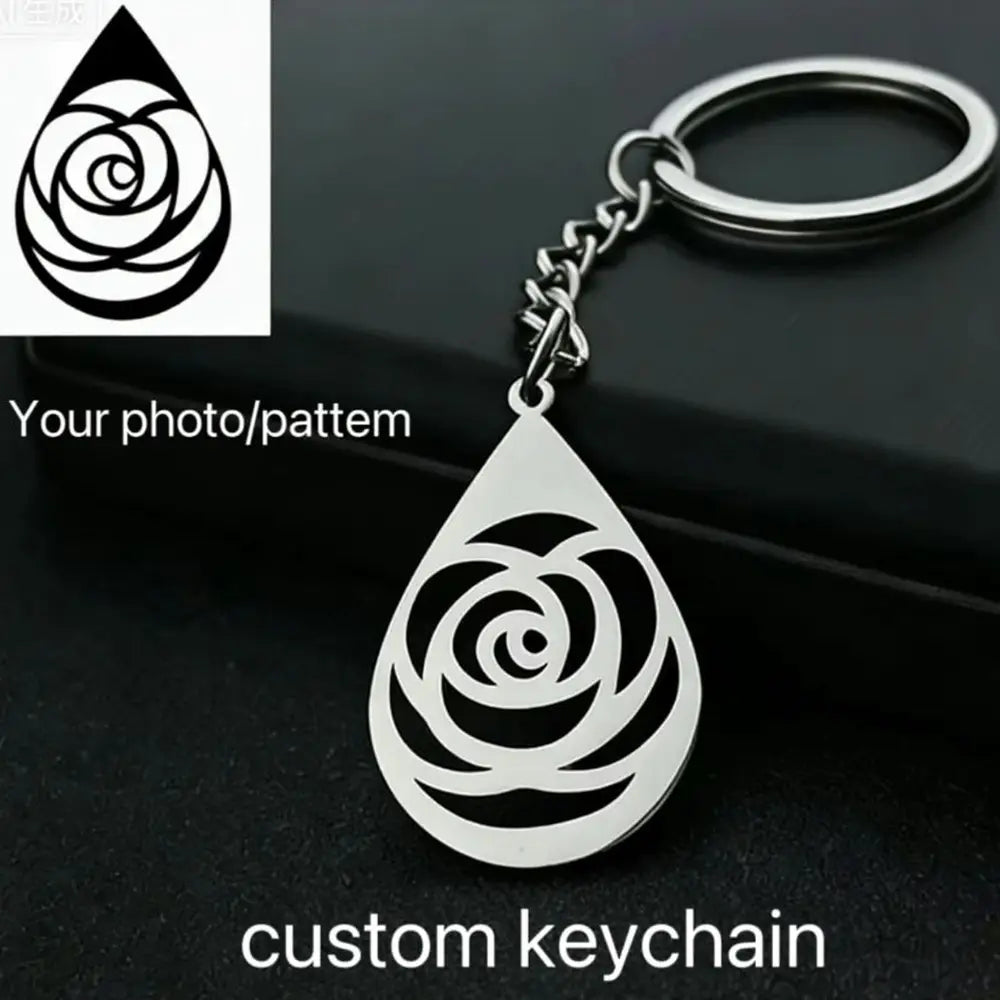 Custom stainless steel logo keychain in silver with a teardrop shape featuring an intricate rose design cutout.