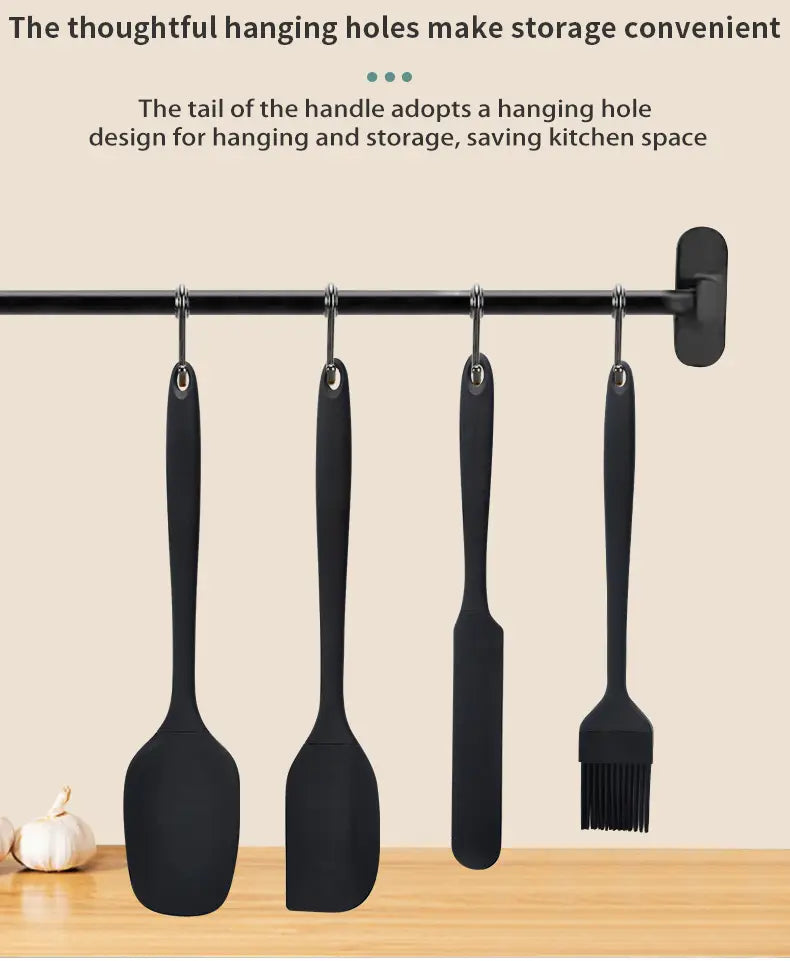 Set of four black silicone kitchen utensils with hanging hooks for convenient storage in a black silicone kitchenware set and baking tool.