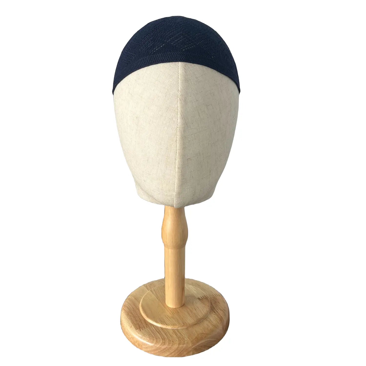 Navy blue knitted kufi beanie prayer cap made of textured fabric displayed on a wooden mannequin head.