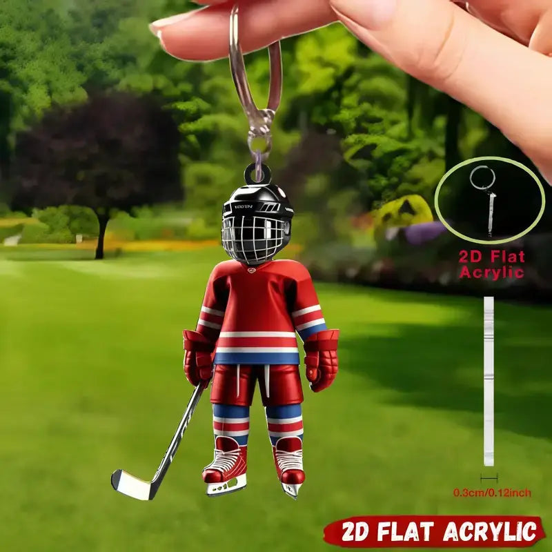 A red and blue hockey player acrylic keychain with black helmet holding a stick designed as a sports backpack charm.