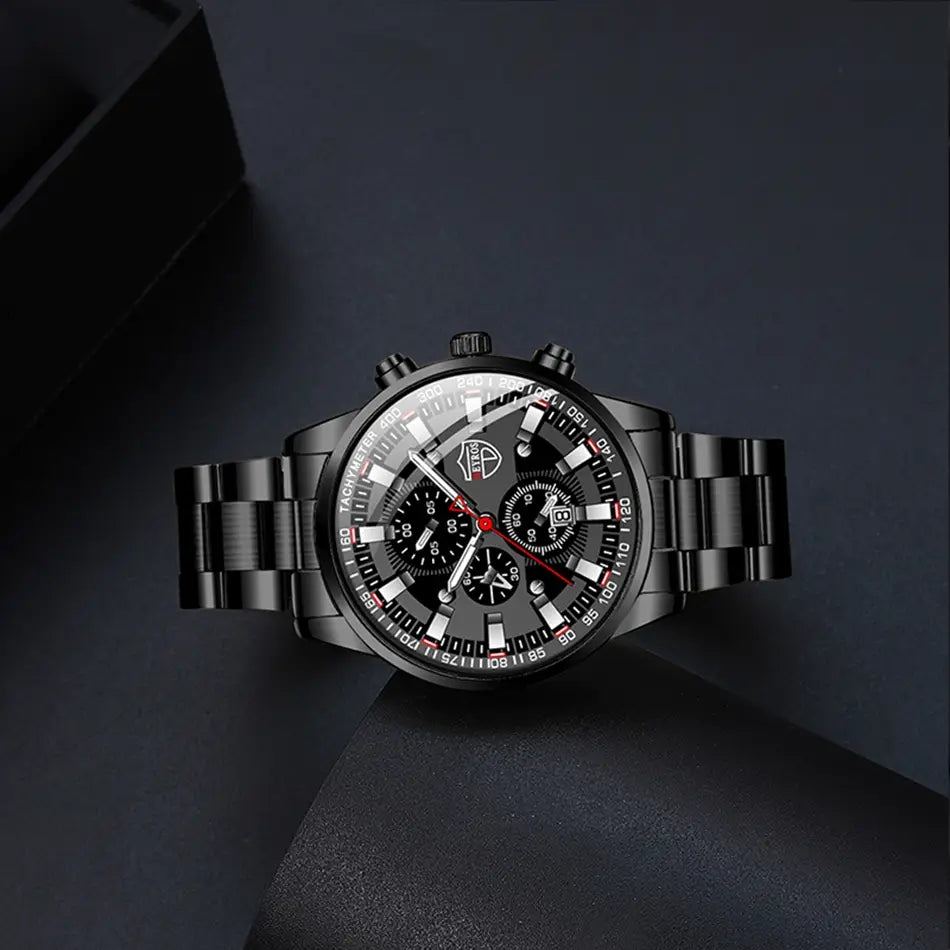Montre pour homme Deyros en acier inoxydable noir, en quartz, avec un design moderne et épuré de chronographe, des index blancs marqués pour les heures et des accents rouges sur les aiguilles.