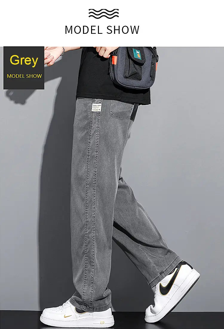 Men’s lyocell casual loose straight drawstring pants in grey with a relaxed fit and subtle fading resembling denim jeans.