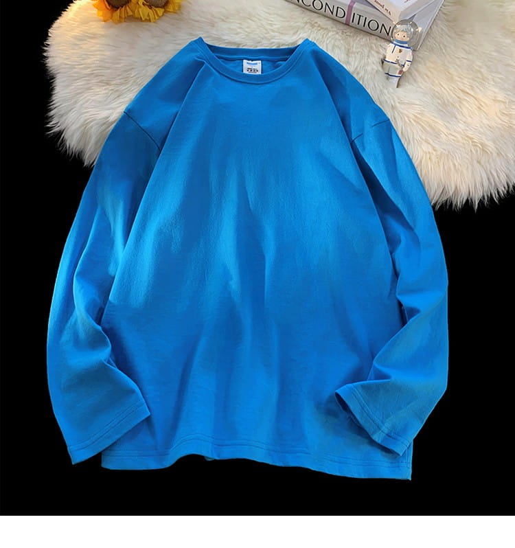 Bright blue oversized long sleeve blank t-shirt made of soft cotton fabric with a crew neck.