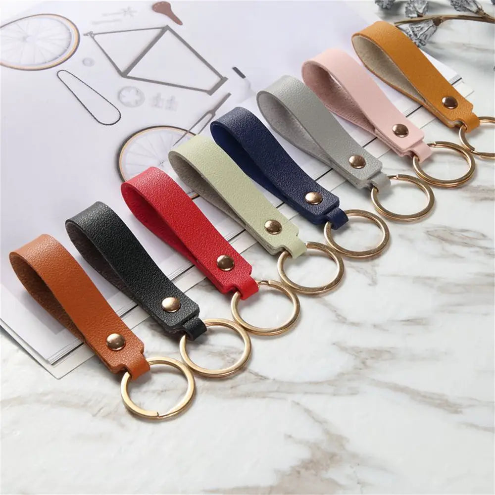 a set of colorful pu leather keychains featuring gold-toned metal keyrings and rivets for fashionable and durable use
