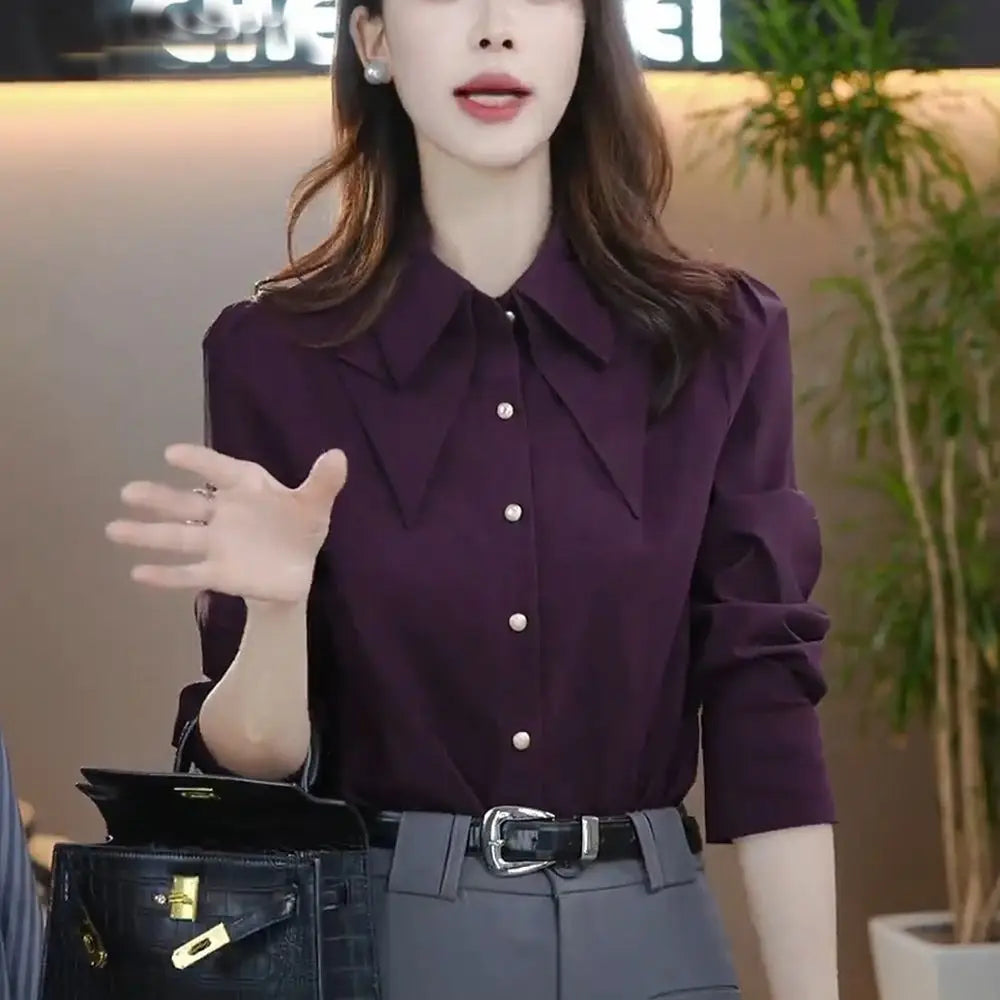 A sleek deep purple satin blouse long sleeve button top with a structured collar and subtle puff sleeves modname=ckeditor.