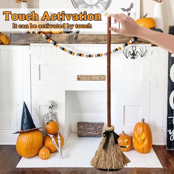 Animated floating witch broom halloween prop with brown wooden handle natural straw bristle head and black ribbon tied around the handle.