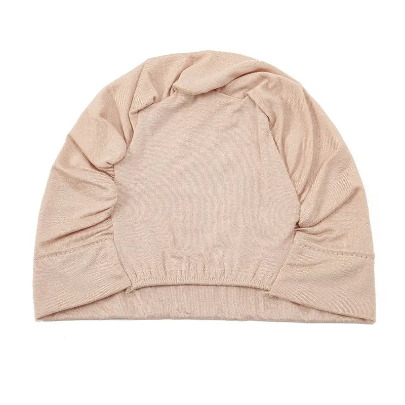 Beige ribbed knit stretchy jersey hijab cap and turban set with elasticated hem and gathered side panels.