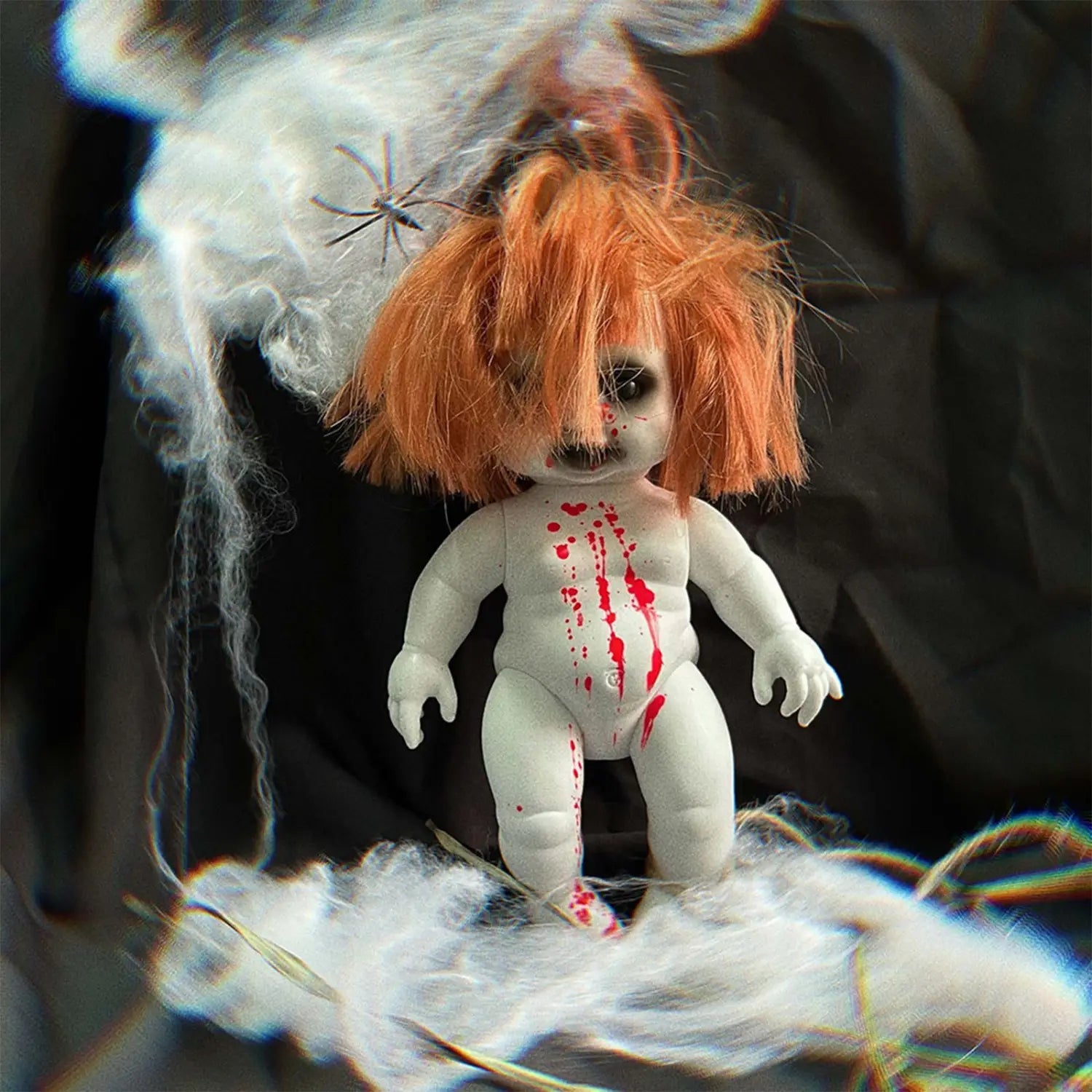 A white plastic Halloween hanging ghost doll with orange hair red paint splatters and a creepy face spooky prop.