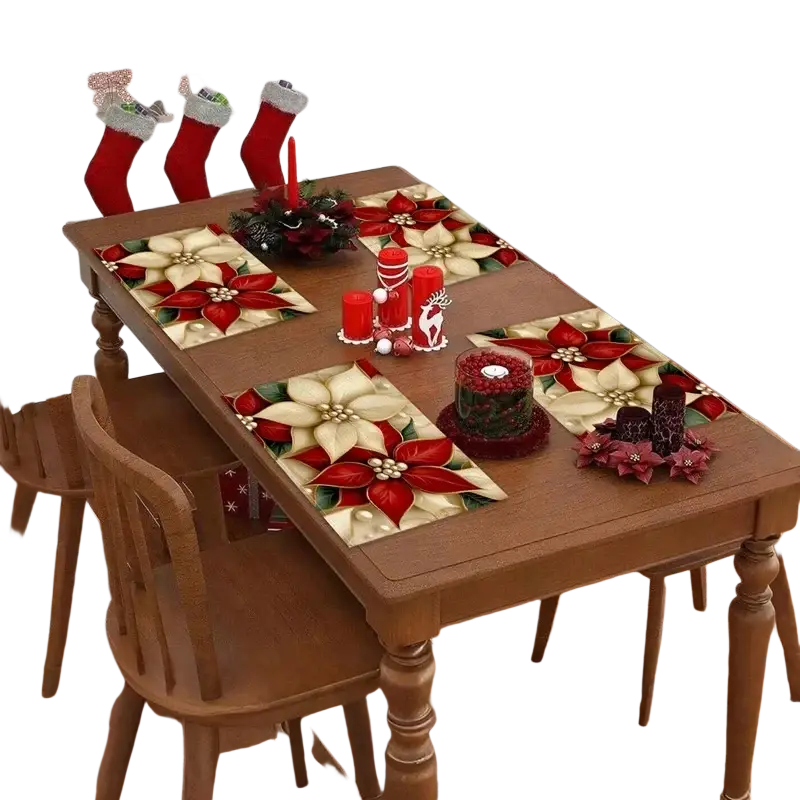 Ensemble de quatre dessous de table festifs pour sapin de Noël rouges et crème, présentant un motif de poinsettia, vue de dessus.