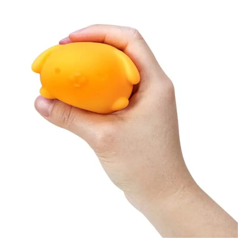 A soft bright orange rounded squishy sensory fidget toy shaped like a cute animal with small ears and feet viewed from the front featuring quick rebound properties.