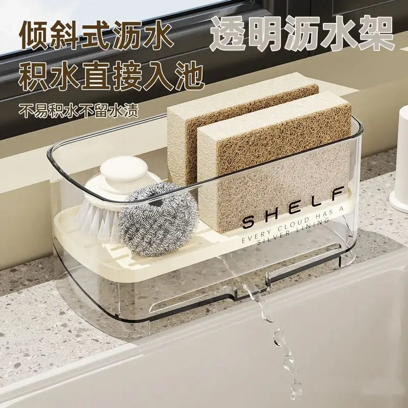 Organizador transparente de fregadero de cocina de plástico con sistema de drenaje, con interior blanco, ribete negro y la palabra estante impresa en su lateral.