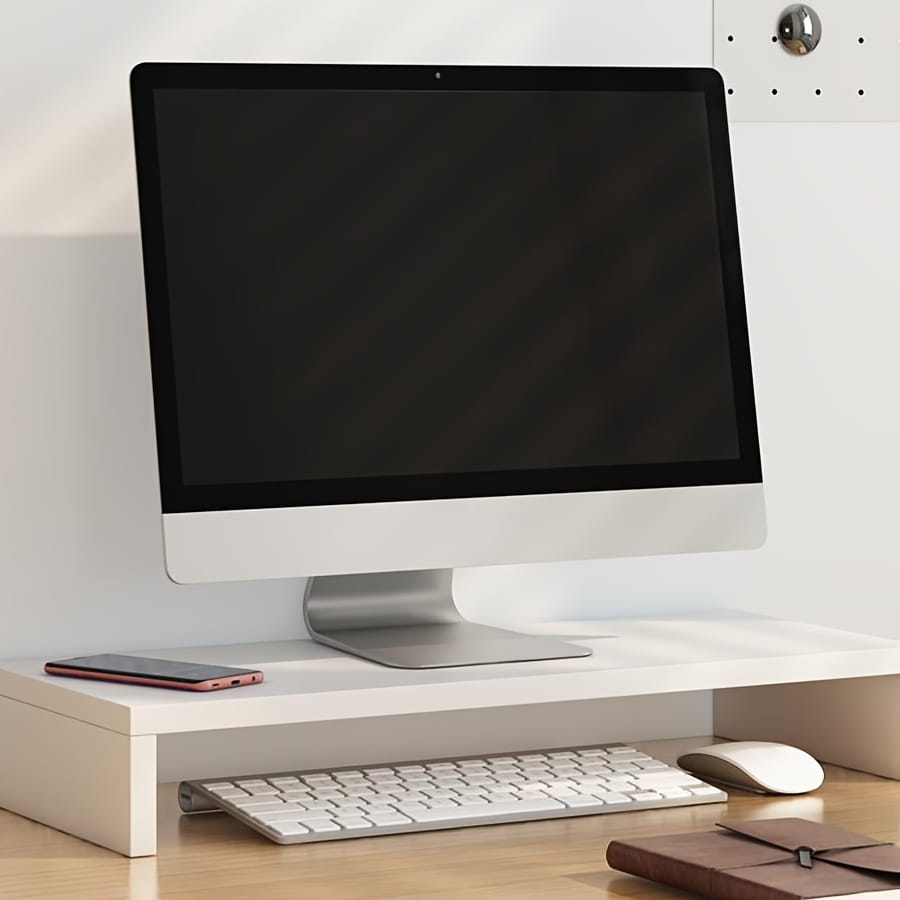 Weißer minimalistischer Schreibtischaufsatz aus widerstandsfähigem Material, der einen silbernen iMac-Monitor mit integrierter Tastaturablage zur ergonomischen Arbeitsplatzzorganisation unterstützt.