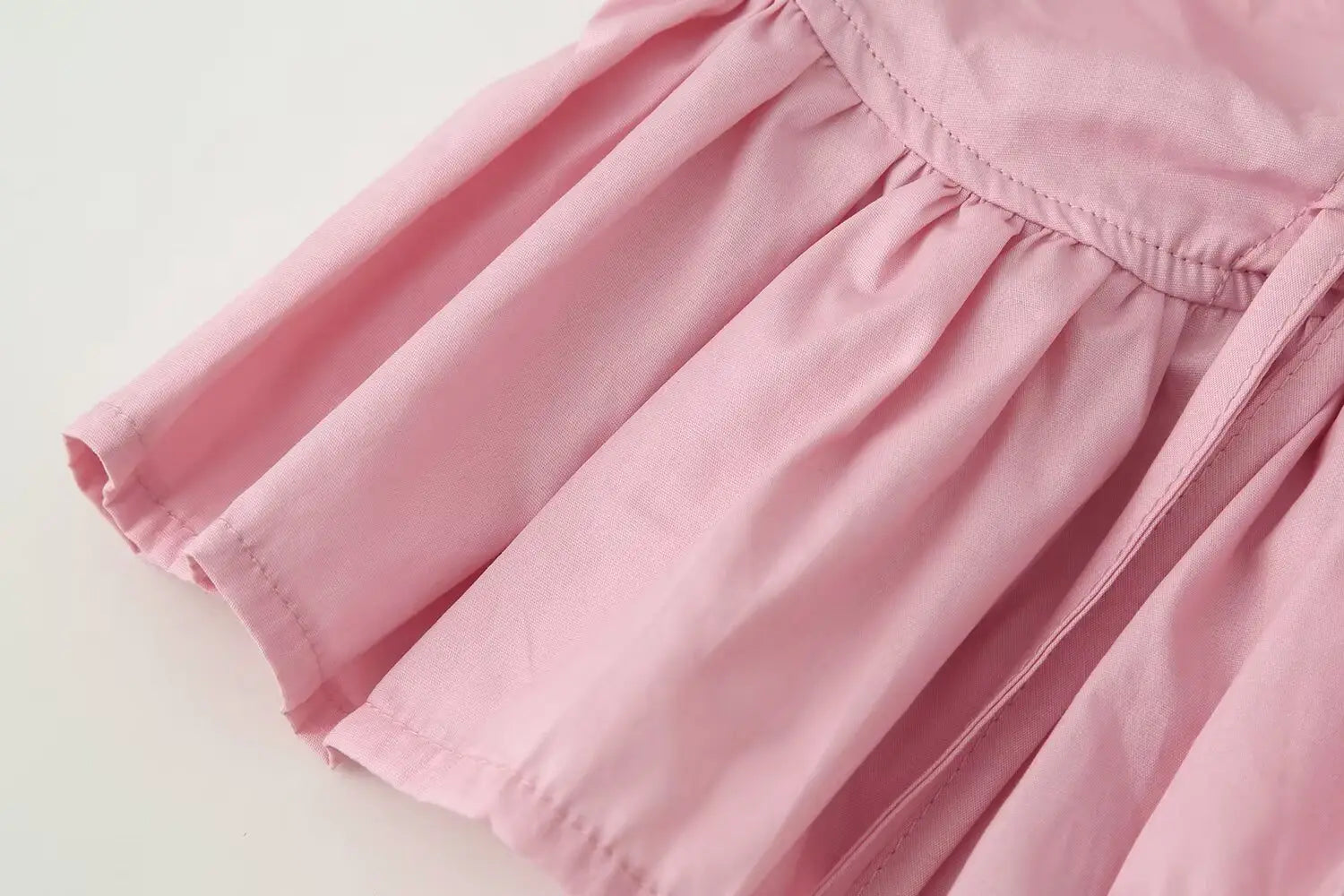 women slim-fit design round neckline long sleeve top paired with a soft pink lightweight cotton skirt featuring a gathered waistband and gentle pleats