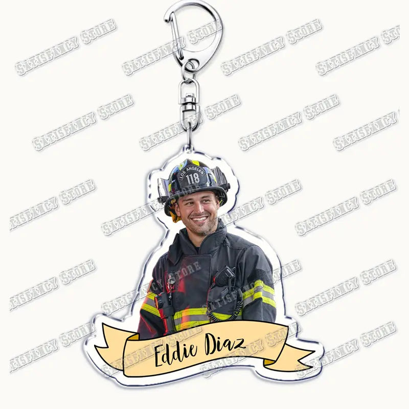 Clear acrylic keychain featuring a smiling firefighter in full gear with los angeles 118 on his helmet and the name eddie diaz printed below from the 9-1-1 tv show firefighter gift collection.